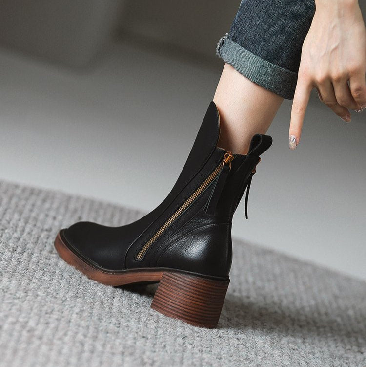 Black ankle boots with side zipper, tassel pull, and block heel