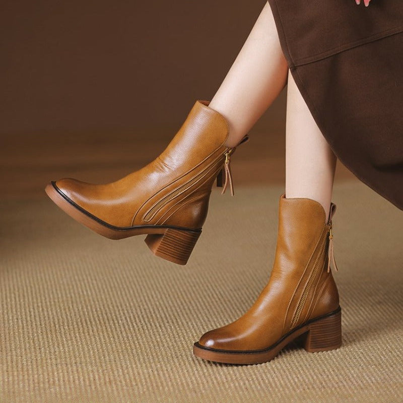 Brown ankle boots with rounded toe, side zipper, and block heel