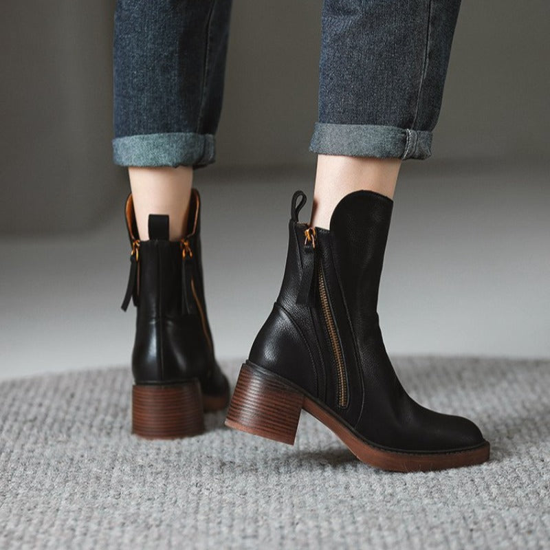 Pair of black ankle boots with side zipper and block heel