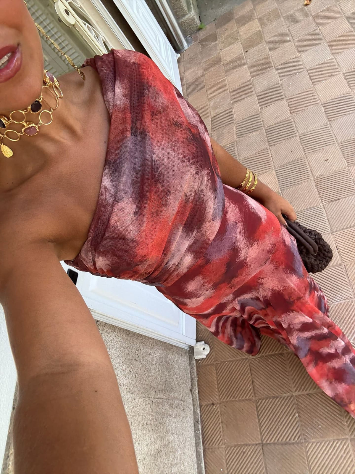 Mira off-shoulder long dress fabric close-up, red and mauve tie-dye drape