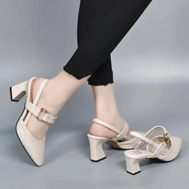 White leather look heeled slingback with ankle strap, gold buckle, and block heel
