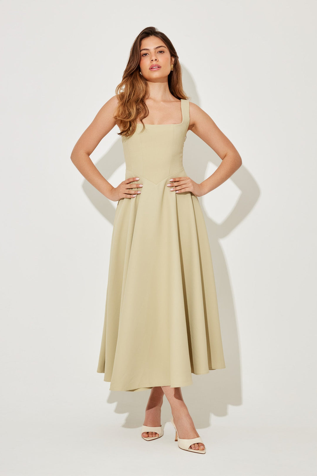 Cream sleeveless midi flow dress with square neckline and pleated skirt