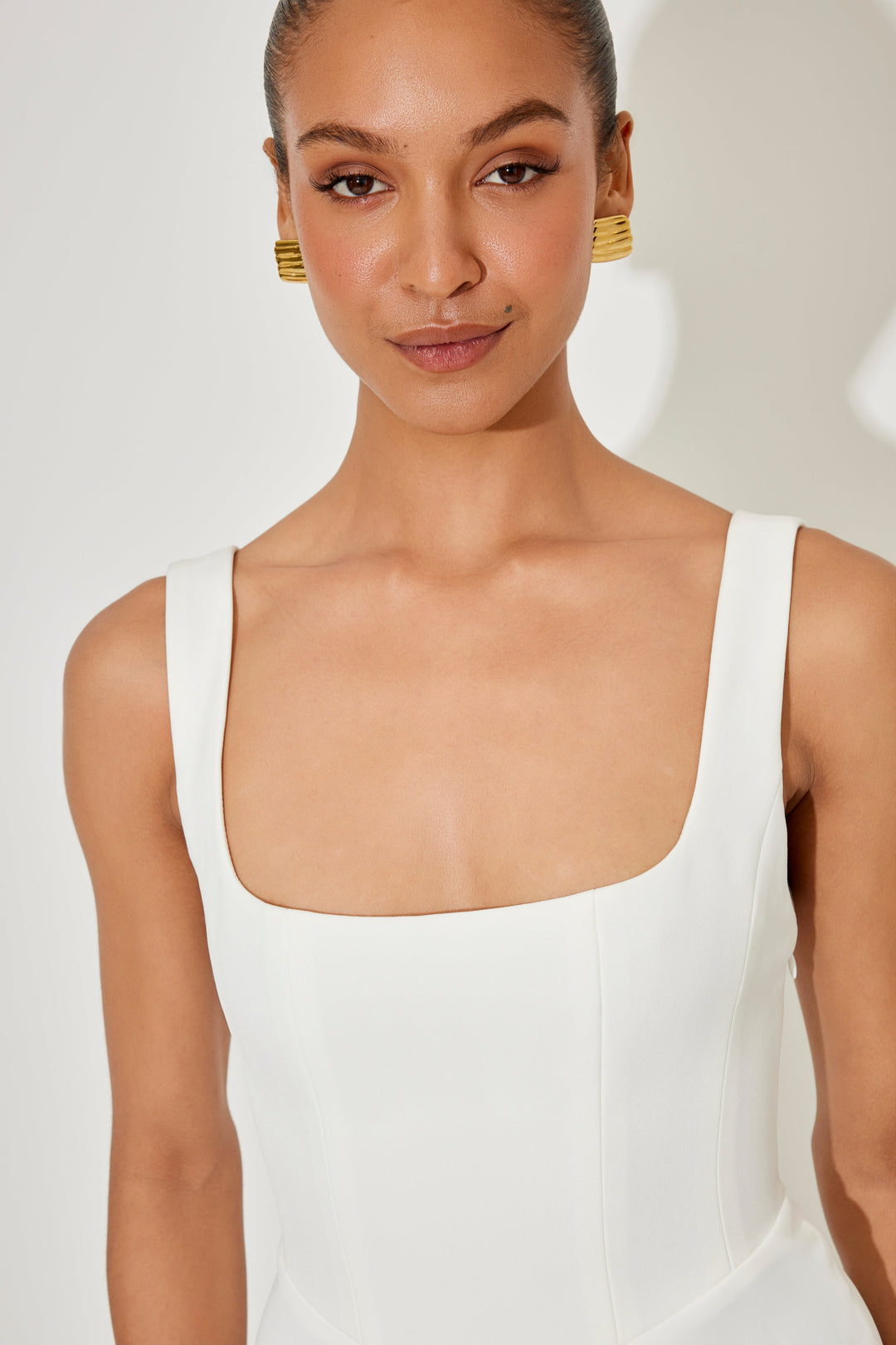 White sleeveless midi dress with square neckline and structured fitted bodice