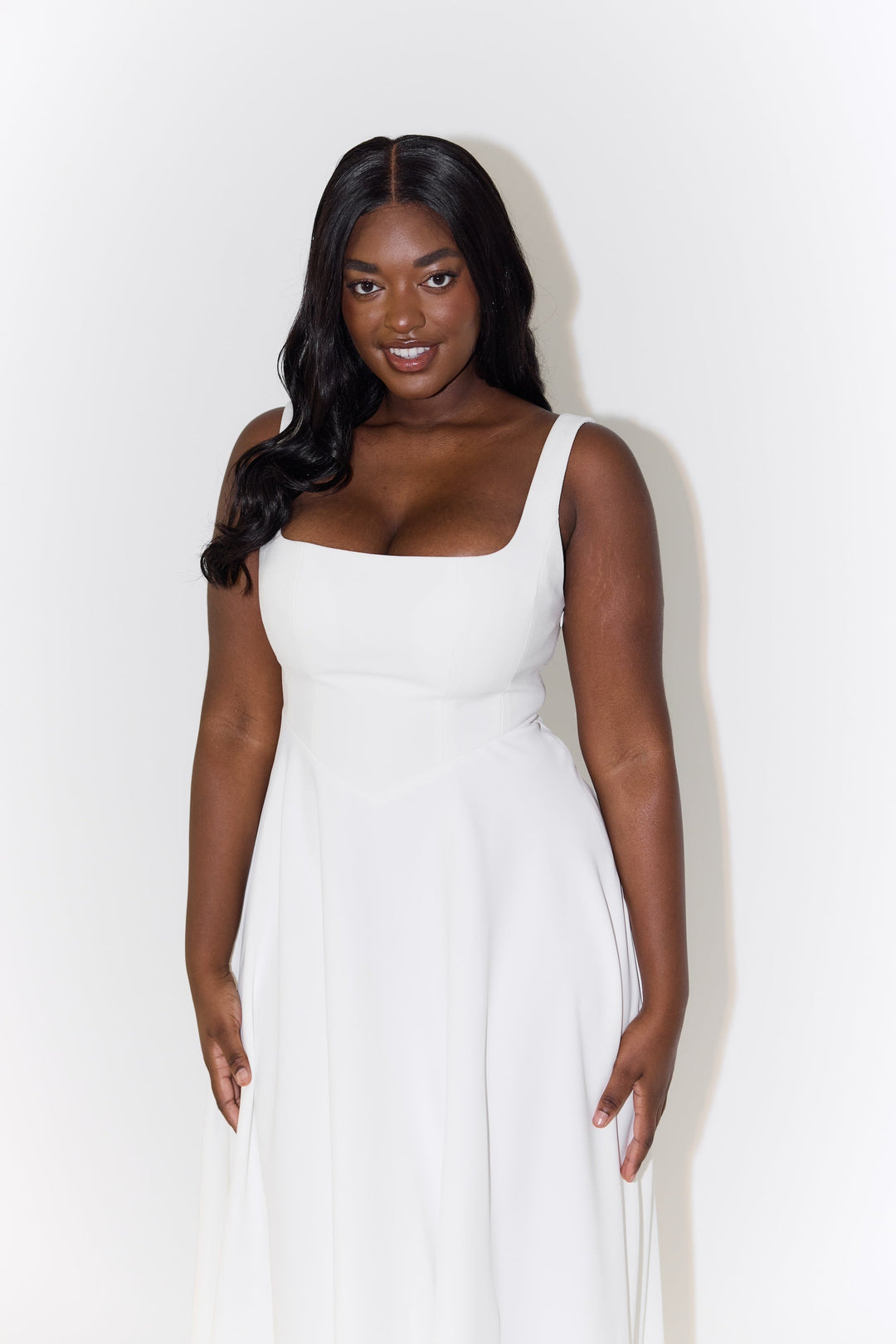 White midi flow dress with square neckline, sleeveless cut, and pleated skirt