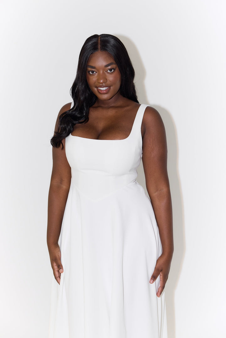 White midi flow dress with square neckline, sleeveless cut, and pleated skirt