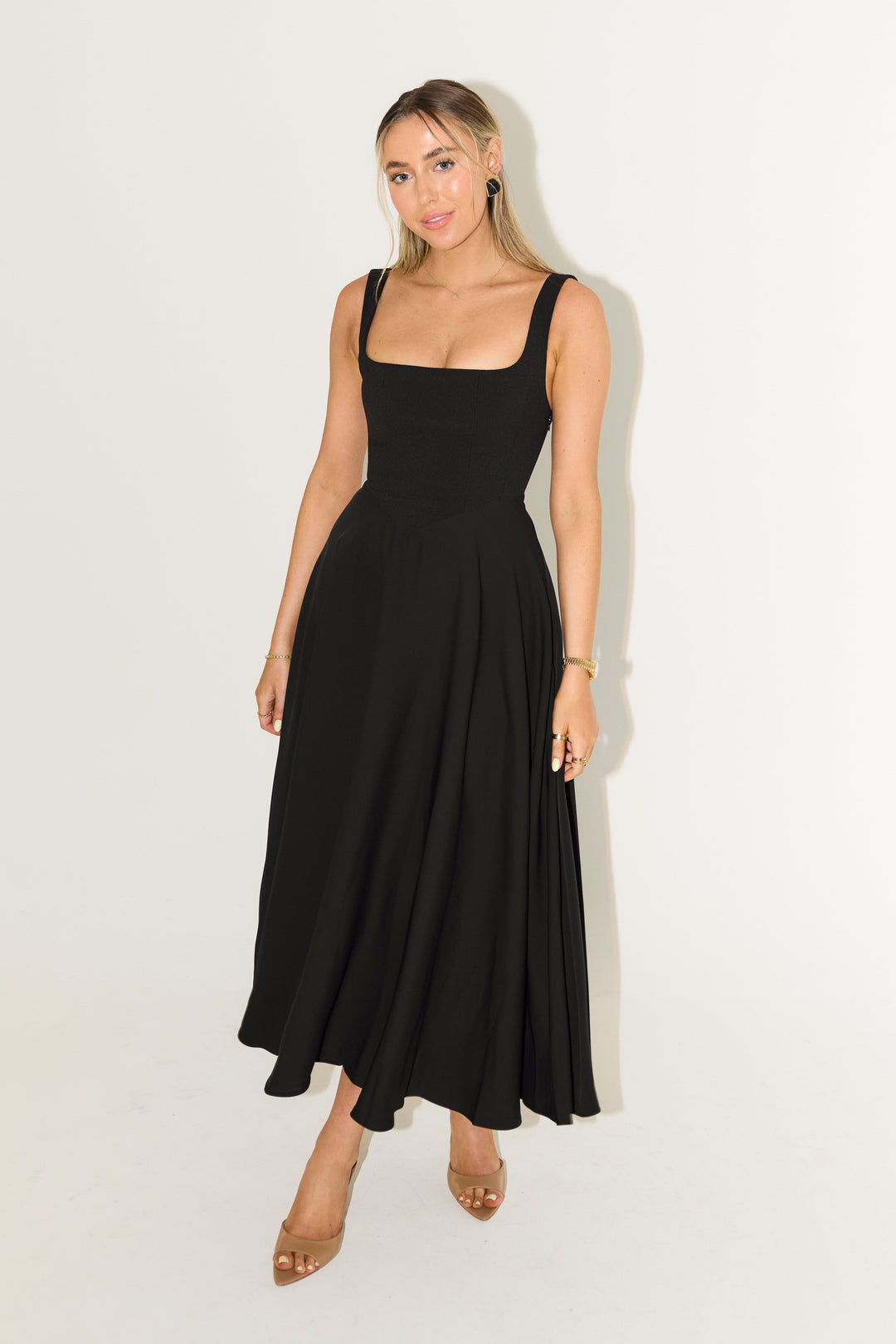 Black sleeveless midi flow dress with square neckline and gathered A-line skirt