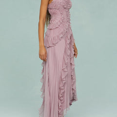 Pink halter maxi dress with layered ruffle detailing and flowing pleated skirt