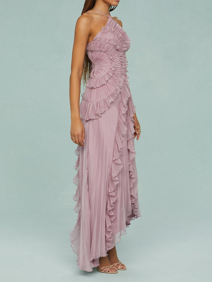 Pink halter maxi dress with layered ruffle detailing and flowing pleated skirt