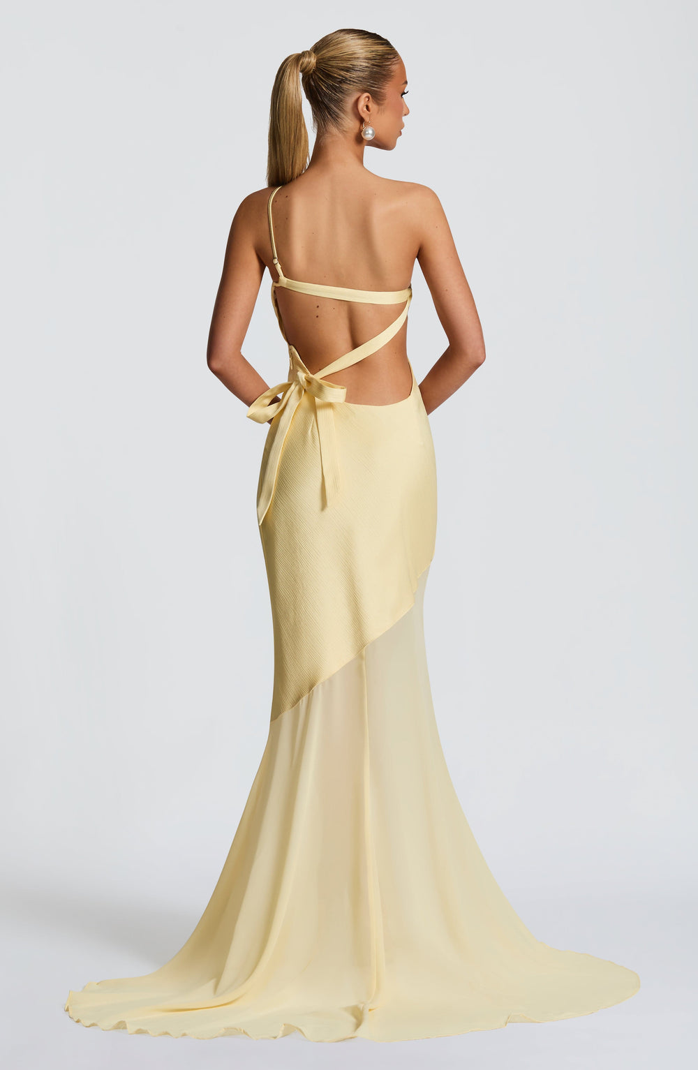 Lemon backless one-shoulder gown with crisscross straps and flowing skirt