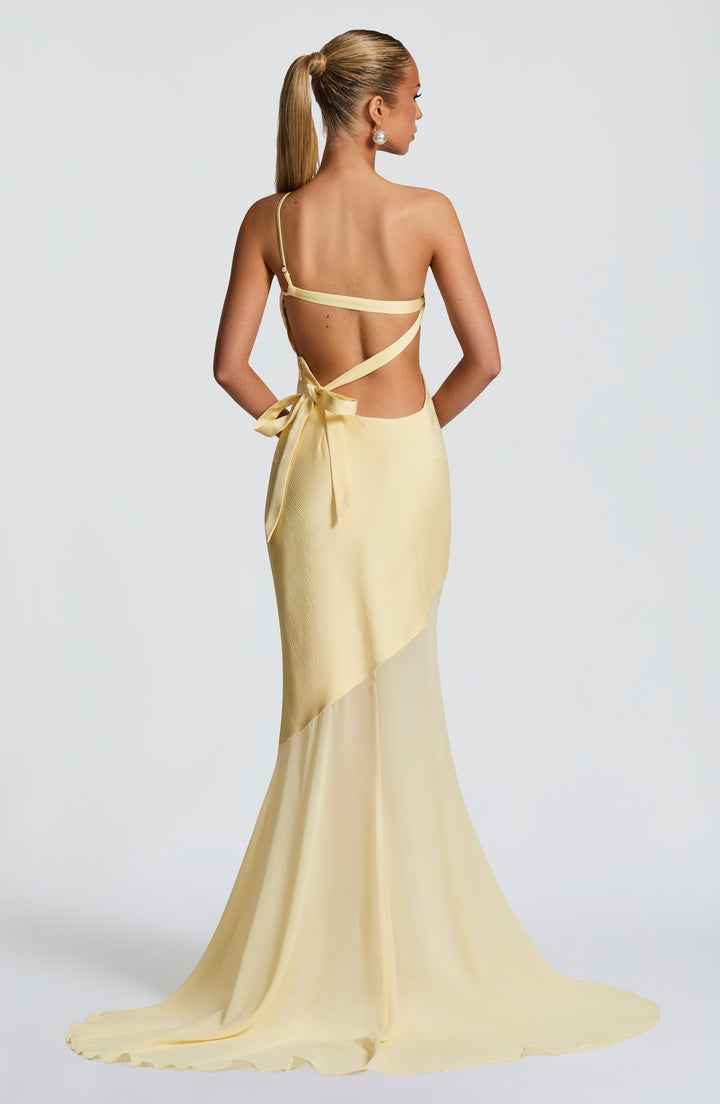 Lemon backless one-shoulder gown with crisscross straps and flowing skirt
