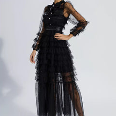Black belted maxi dress with layered tulle skirt and sheer polka-dot long sleeves