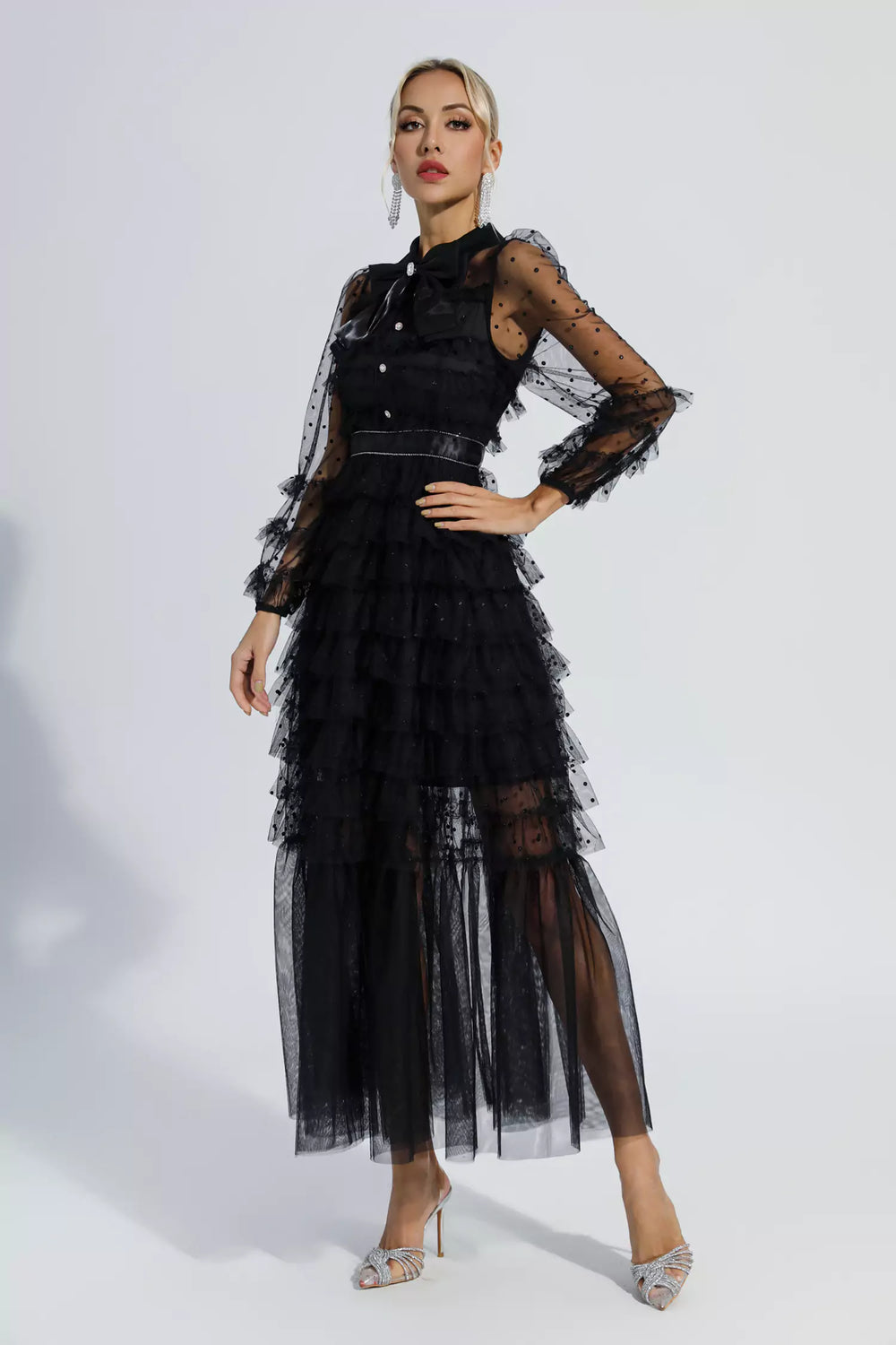 Black belted maxi dress with layered tulle skirt and sheer polka-dot long sleeves