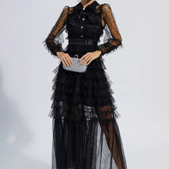 Black tiered maxi dress with sheer polka-dot sleeves, button front, and clutch