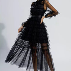 Black tiered maxi dress with sheer polka-dot sleeves and open back view, belted waist
