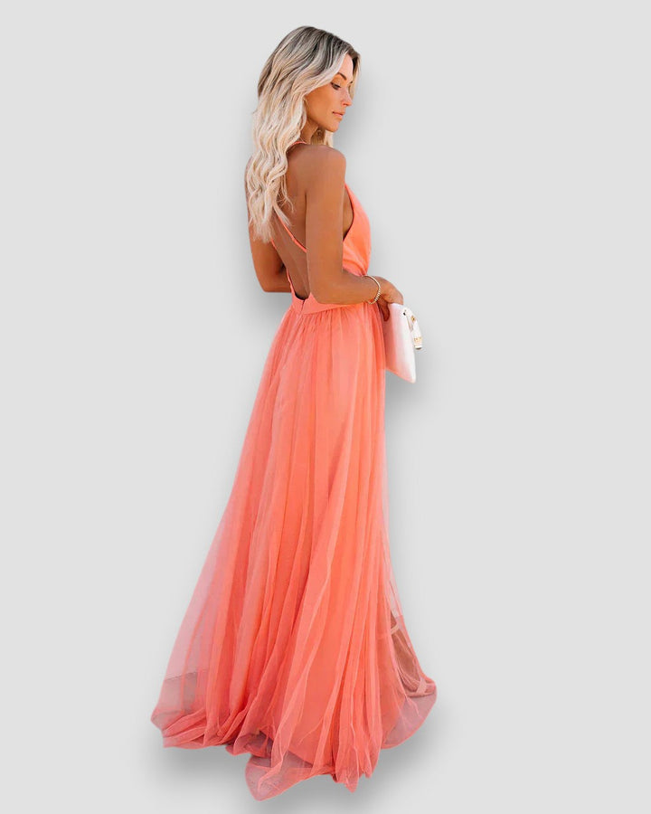 Peach halter maxi dress with flowy pleated skirt and open-back straps