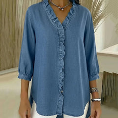 Light blue denim blouse with ruffled V-neck and button-front placket
