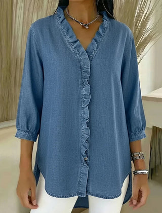Light blue denim blouse with ruffled V-neck and button-front placket