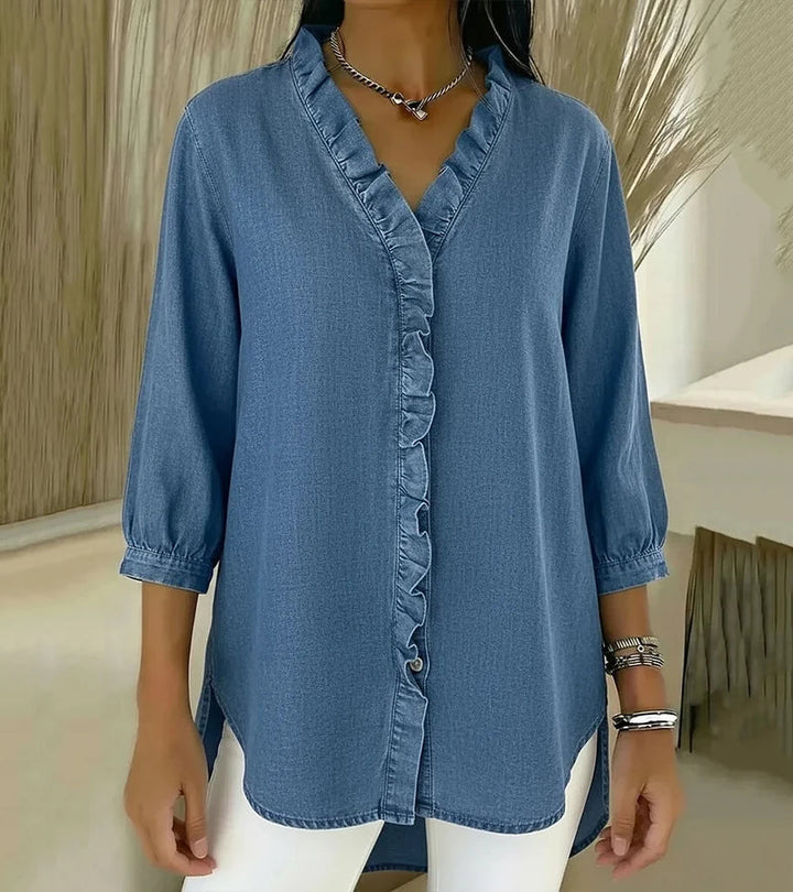 Light blue denim blouse with V-neck and ruffled button-front placket