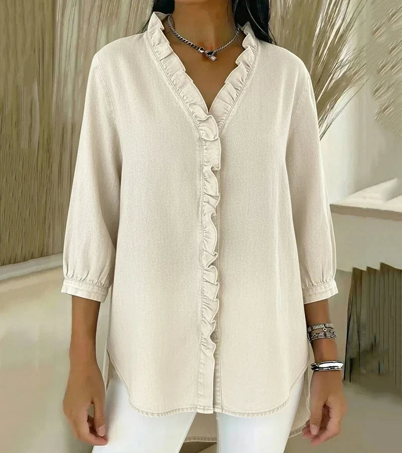 White denim blouse with ruffled V-neck and button-front placket, three-quarter sleeves