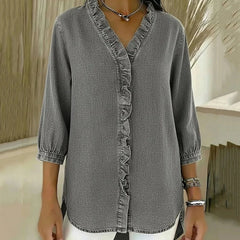 Gray denim blouse with ruffled V-neck and button-front placket, elbow-length sleeves