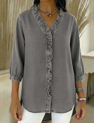 Gray denim blouse with ruffled V-neck and button-front placket, elbow-length sleeves