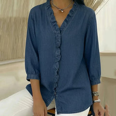 Blue denim blouse with ruffle V-neck and elbow-length sleeves, button front