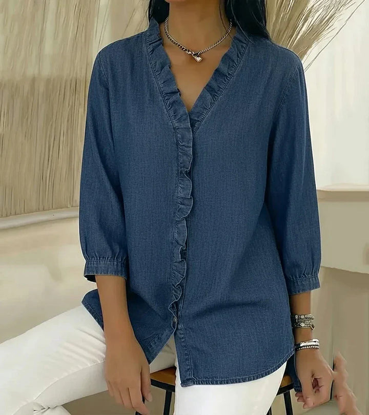 Blue denim blouse with ruffle V-neck and elbow-length sleeves, button front