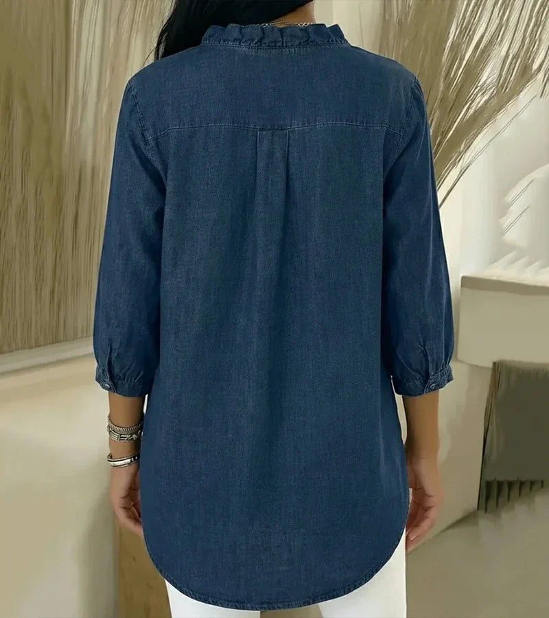 Back view of dark blue denim blouse with gathered yoke and 3/4 sleeves
