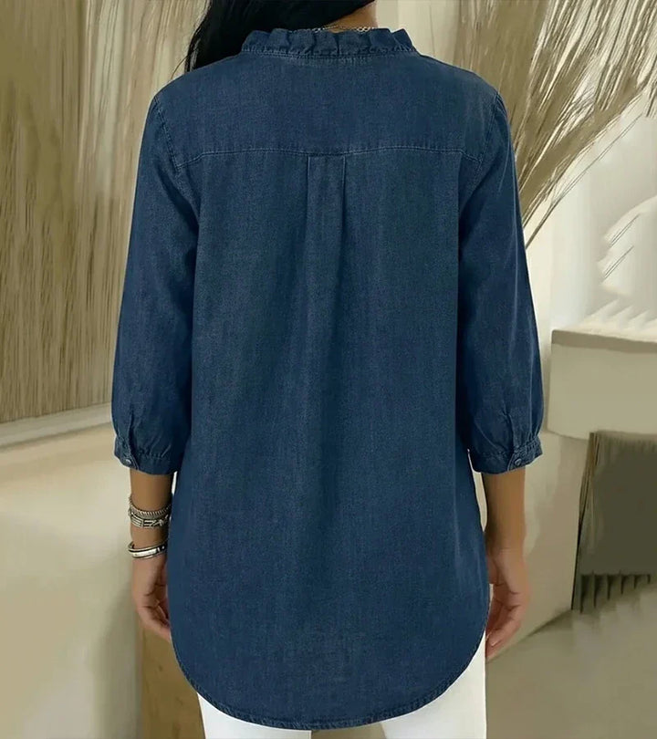 Back view of dark blue denim blouse with gathered yoke and 3/4 sleeves