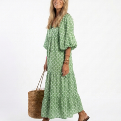 Green patterned midi dress with V-neck, three-quarter puff sleeves, flowy skirt