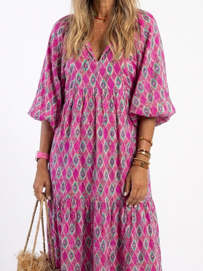 Purple patterned midi dress close-up: V-neck, gathered waist, puff sleeves