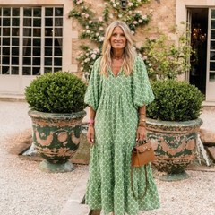 Green patterned midi dress with V-neck and three-quarter puff sleeves, flared hem