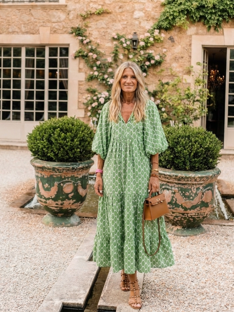 Green patterned midi dress with V-neck and three-quarter puff sleeves, flared hem