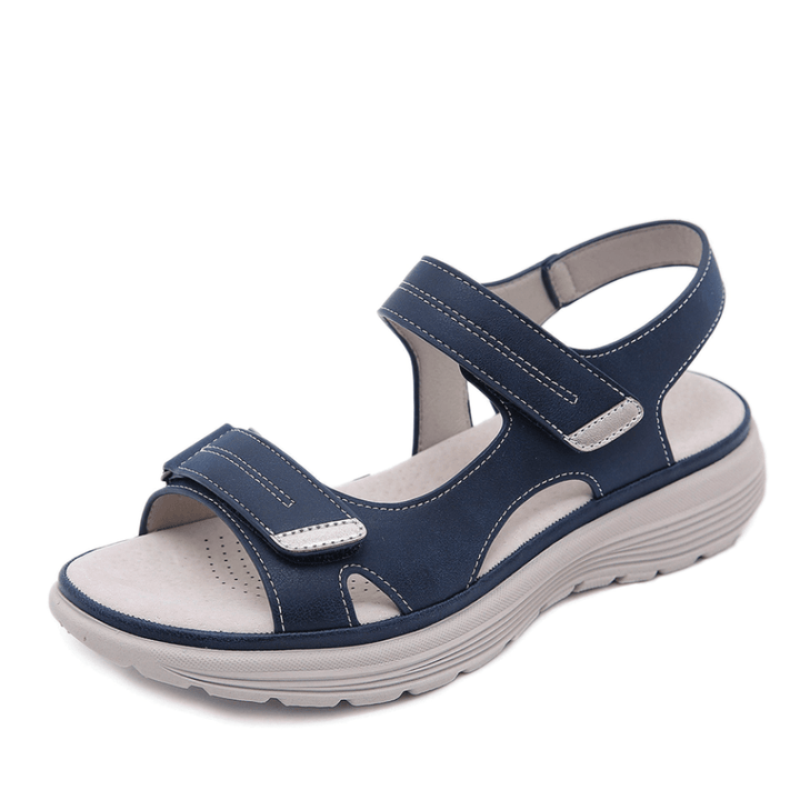 Blue orthopedic sandals with cross straps, hook-and-loop closure, and platform sole