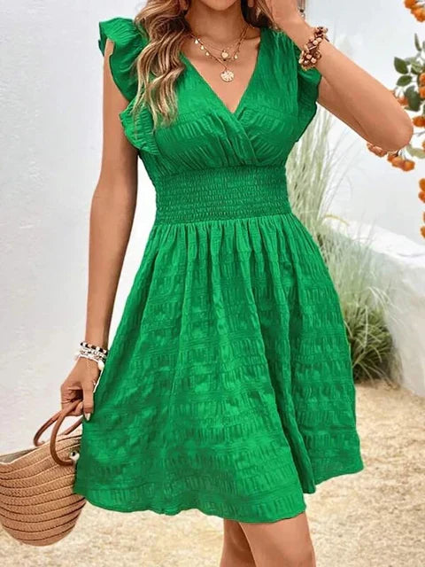 Green V-neck summer dress with ruffled cap sleeves and tiered skirt