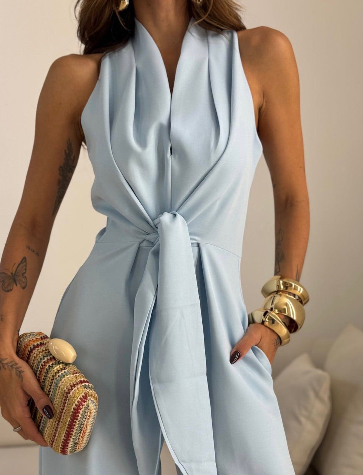 Sky blue halter cowl-neck jumpsuit with waist tie and draped sleeveless fit