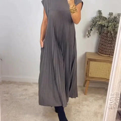 Gray sleeveless pleated maxi dress with round neck and vertical pleats.