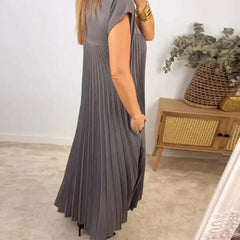 Gray sleeveless pleated maxi dress with round neck and vertical pleats, side view.