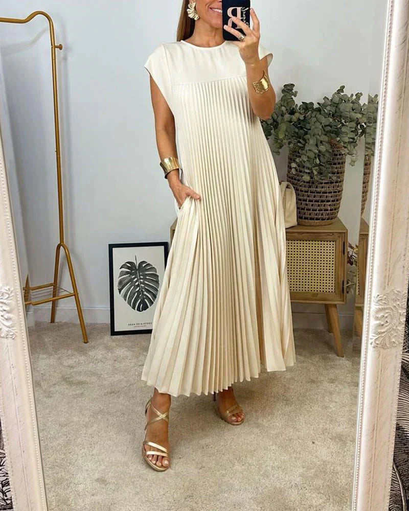 Cream sleeveless pleated maxi dress with round neckline and gathered pleat panels.