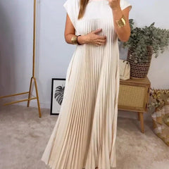 Cream sleeveless pleated maxi dress with round neck and vertical pleats.