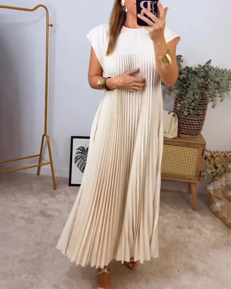 Cream sleeveless pleated maxi dress with round neck and vertical pleats.