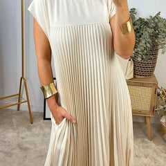 Cream sleeveless pleated maxi dress with round neck and vertical pleated bodice.