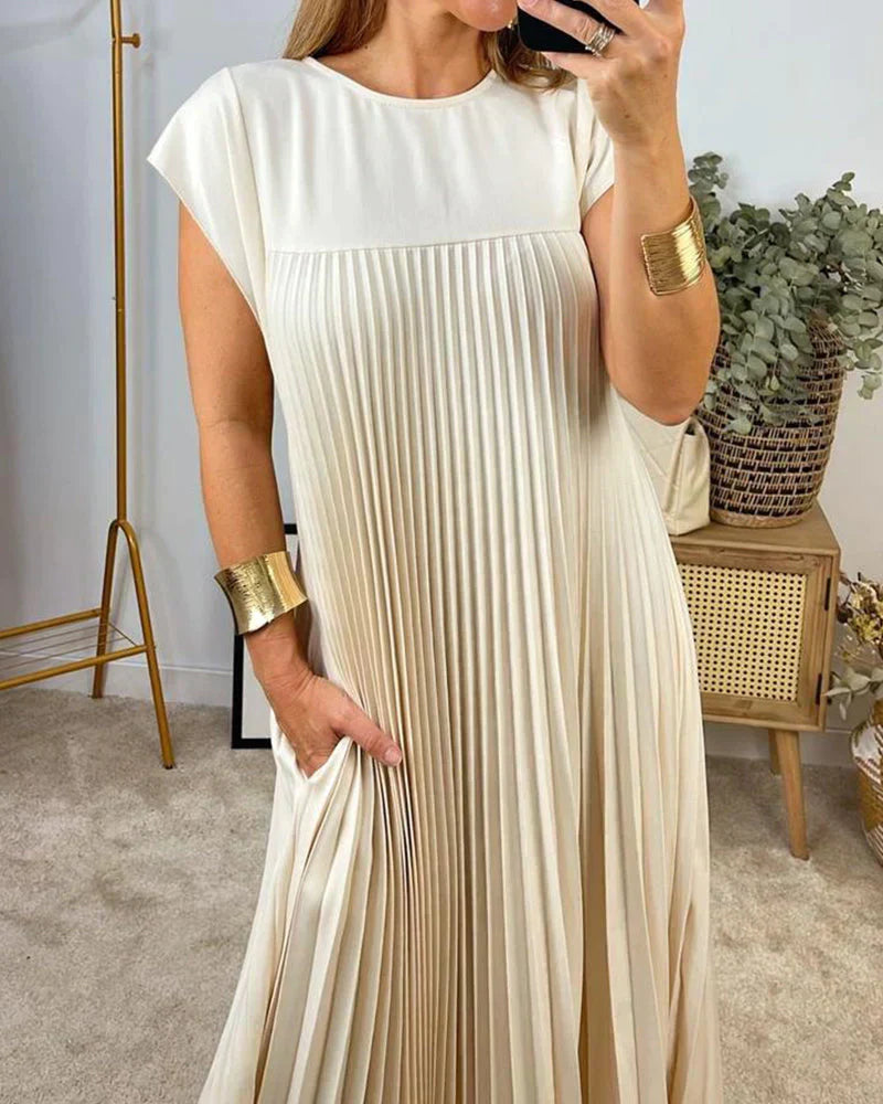 Cream sleeveless pleated maxi dress with round neck and vertical pleated bodice.