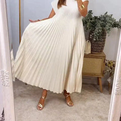 Cream sleeveless pleated maxi dress with round neck and deep pleated skirt.