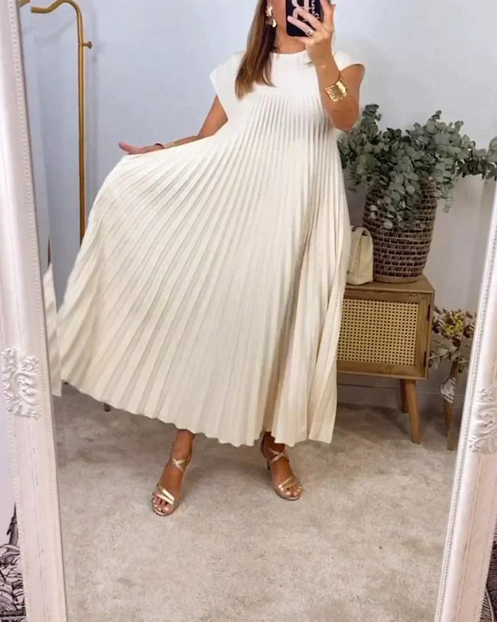 Cream sleeveless pleated maxi dress with round neck and deep pleated skirt.