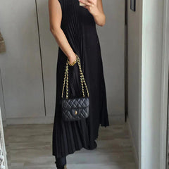 Black sleeveless pleated midi dress, round neckline, flowing pleats.