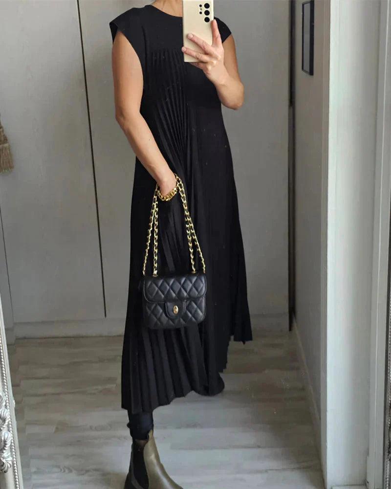 Black sleeveless pleated midi dress, round neckline, flowing pleats.