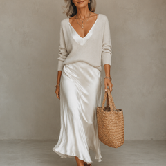 White two-piece set with knit V-neck sweater and satin midi skirt