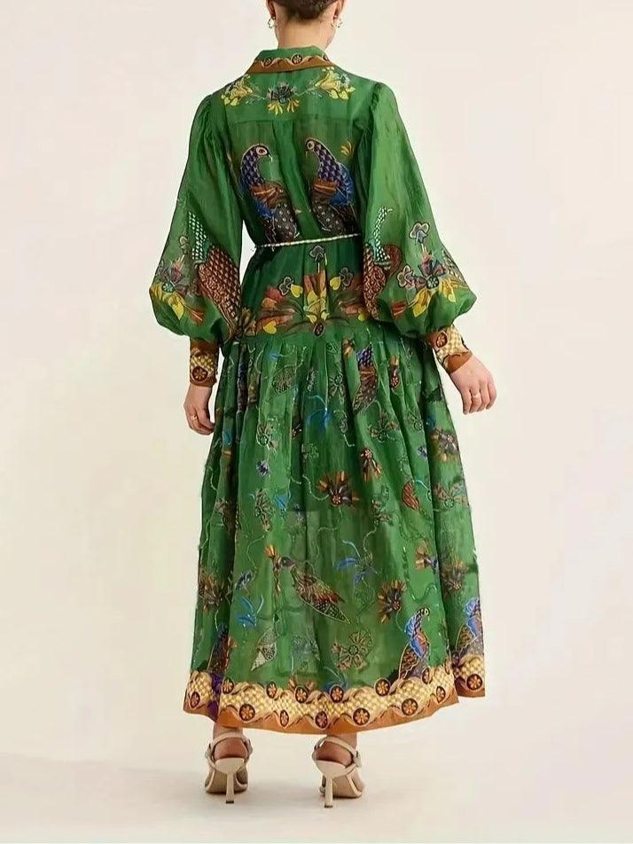 Green floral print maxi dress with puff sleeves, gathered tiers, and belt at back