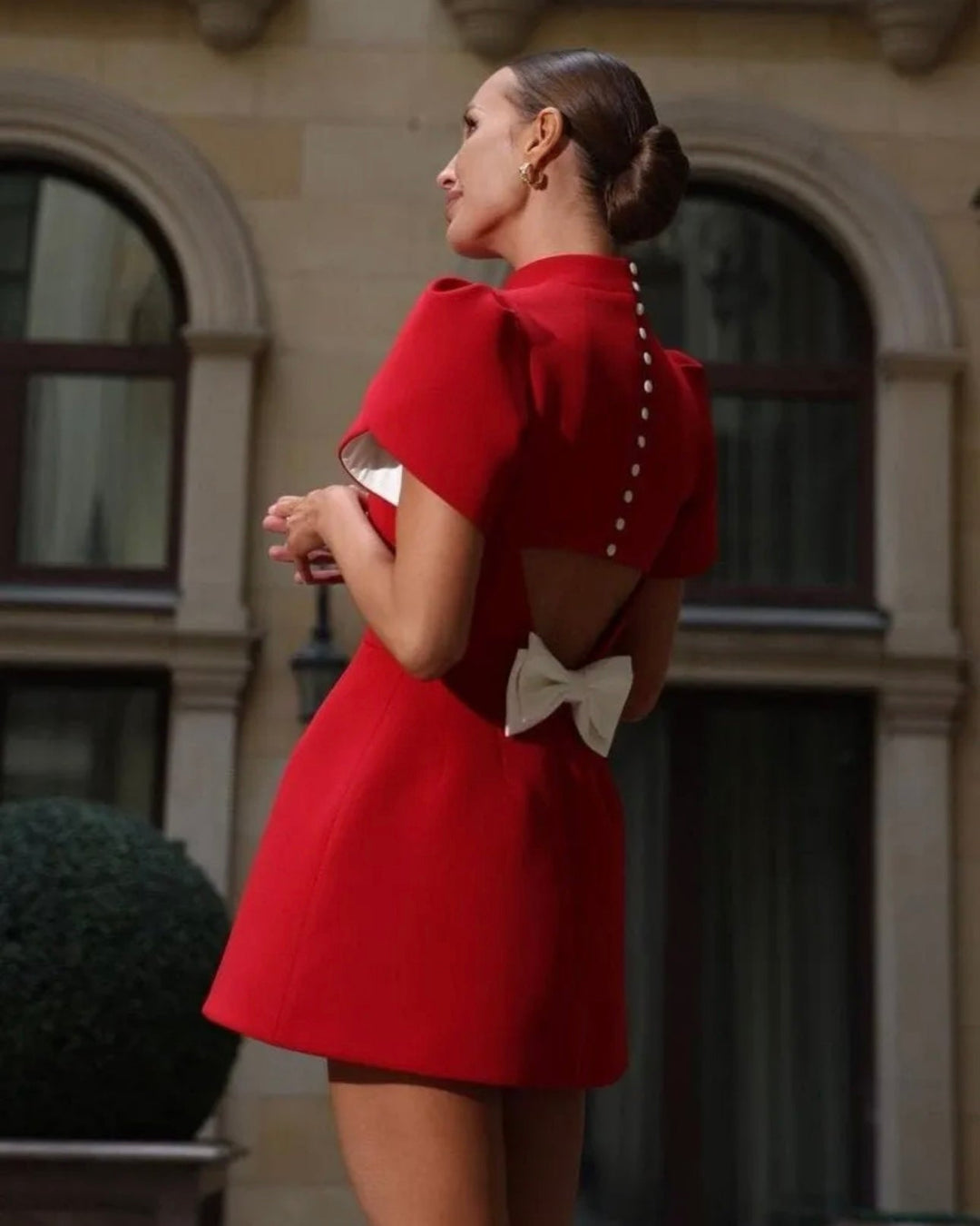 Red ribbon mini dress with flared short sleeves and back bow detail